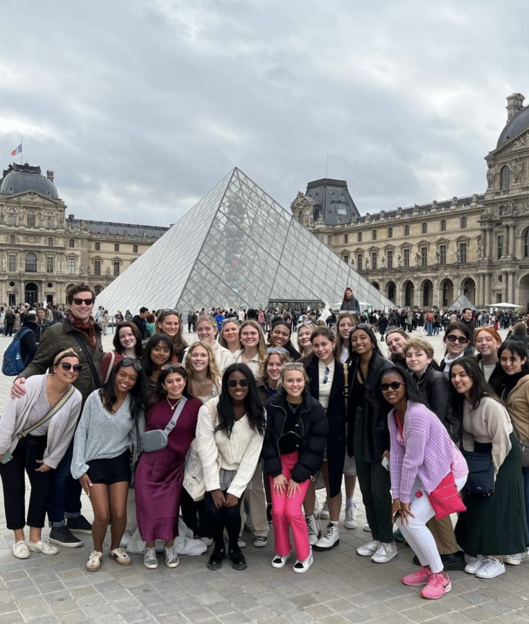 Students pose for the camera before going inside the Louvre for a tour of the museum. 