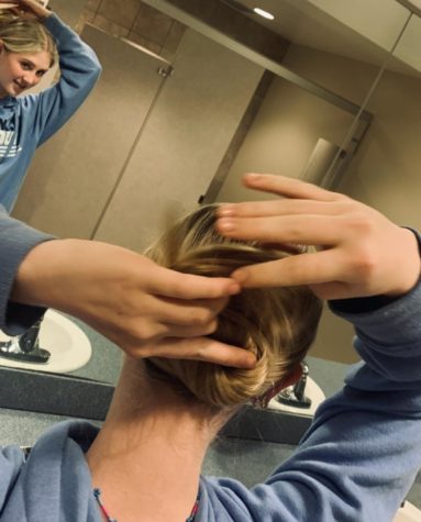  Rosamond Mullinax wraps her hair into a bun to get ready for her Dracula rehersal. She has spent most of the first semester of her junior year leaving school during the day for ballet. 