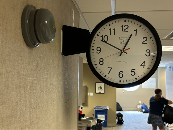 The bell and the clock sit side by side, out of synch with each other. The technology team has been working hard to solve the problem, but they are not sure when the bells will be fixed. 