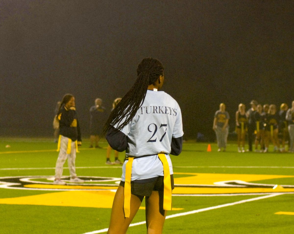 A member of the Sophomore powderpuff team takes the field in her customized t shirt. 