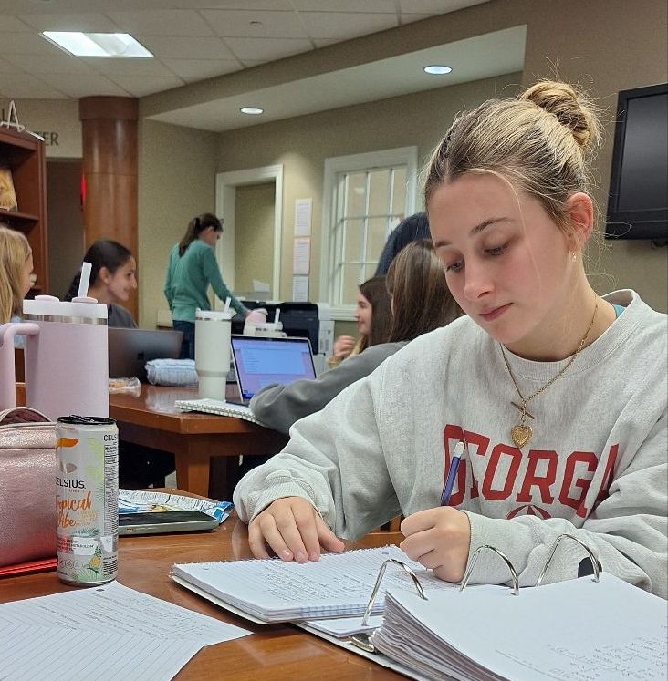 Senior Langston Scrugham studies in the library while sipping on an energy drink. 